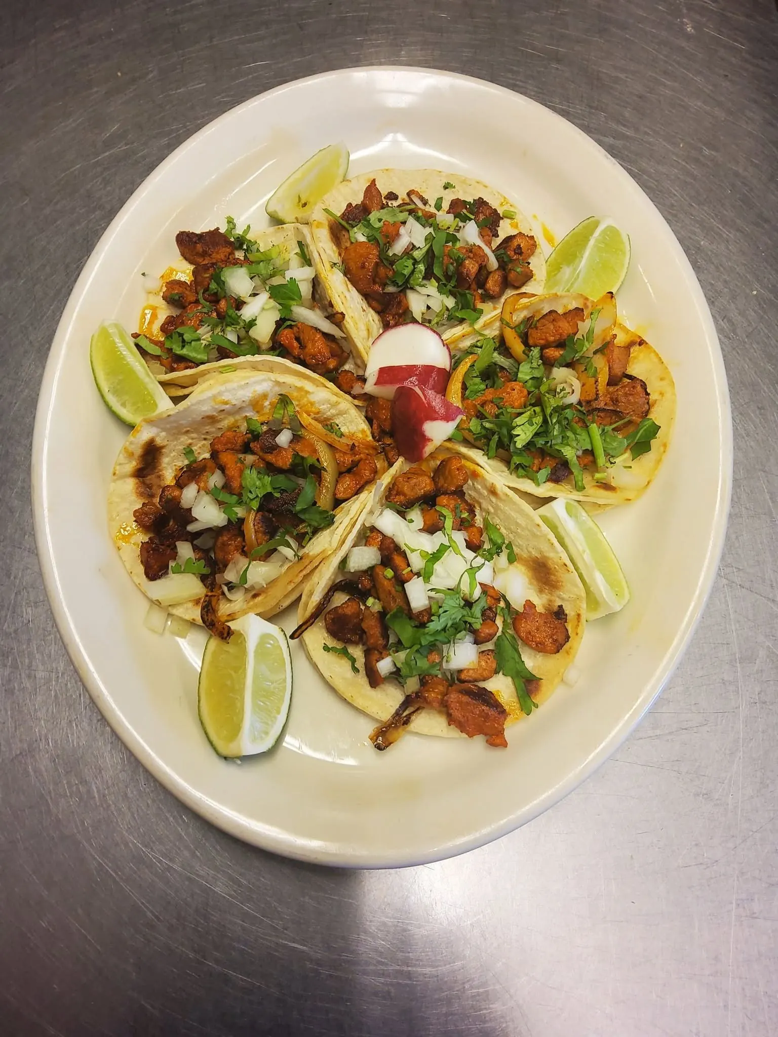 Tacos al pastor with cilantro, onion, and lime at Isabel's Bakery